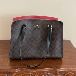 This is a slightly used coach bag. It has three compartments